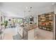 Open-concept kitchen with granite island, stainless steel appliances, and seamless flow to dining and living areas at 7012 White Willow Ct, Sarasota, FL 34243