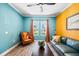 Eclectic living room featuring colorful walls, comfortable seating, wood floors, and natural light at 7012 White Willow Ct, Sarasota, FL 34243