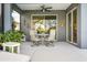 Screened patio with a ceiling fan, dining table, and comfortable seating area at 7012 White Willow Ct, Sarasota, FL 34243