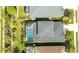 Aerial shot of a backyard featuring a screened-in pool and lush greenery at 7012 White Willow Ct, Sarasota, FL 34243