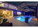 Inviting screened-in pool with underwater lights, adjacent to an outdoor dining area at 7012 White Willow Ct, Sarasota, FL 34243
