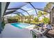 Screened pool with lounge seating and manicured landscaping offers a relaxing outdoor retreat at 7012 White Willow Ct, Sarasota, FL 34243