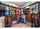 A walk-in closet with custom shelving and rods for optimal clothing storage at 7012 White Willow Ct, Sarasota, FL 34243