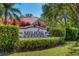 An elegant entrance sign for Melrose Gardens surrounded by lush landscaping at 7128 Melrose Pl, Bradenton, FL 34203