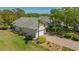 An aerial view of a charming home featuring a brick driveway, lush landscaping, and a well-manicured lawn at 7133 Victoria Cir, University Park, FL 34201