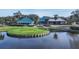 Aerial view of community clubhouse overlooking a pond and golf course at 7133 Victoria Cir, University Park, FL 34201
