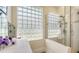 Bright bathroom with a glass block window, shower, and white vanity, offering a clean and modern aesthetic at 7133 Victoria Cir, University Park, FL 34201