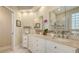 Elegant bathroom featuring double sinks, granite countertops, and a walk-in shower, perfect for a spa-like experience at 7133 Victoria Cir, University Park, FL 34201