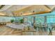 Bright dining room featuring elegant chandeliers, wood floors, and large windows with scenic views at 7133 Victoria Cir, University Park, FL 34201