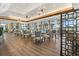 Elegant dining room with hardwood floors, modern chandeliers, and large windows with a view at 7133 Victoria Cir, University Park, FL 34201
