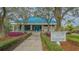 Tennis and Fitness center exterior with manicured landscaping at 7133 Victoria Cir, University Park, FL 34201
