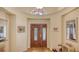 Elegant foyer featuring beautiful hardwood floors, a grand arched entryway, and high ceilings with decorative trim at 7133 Victoria Cir, University Park, FL 34201