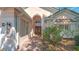 Elegant home featuring a brick entryway, lush landscaping, and beautiful curb appeal with a quaint front entrance at 7133 Victoria Cir, University Park, FL 34201
