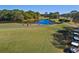 Scenic golf course view featuring a putting green, pond, and lush landscaping at 7133 Victoria Cir, University Park, FL 34201