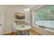 Eat-in kitchen features lots of natural light, hardwood floors, and a built-in window seat at 7133 Victoria Cir, University Park, FL 34201