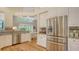 Spacious kitchen with stainless steel refrigerator, white cabinets, and granite countertops, perfect for modern living at 7133 Victoria Cir, University Park, FL 34201