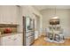 Eat-in kitchen with stainless steel refrigerator, hardwood floors, and granite countertops at 7133 Victoria Cir, University Park, FL 34201