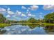 Scenic lake view reflecting the sky and lush greenery, offering a tranquil and picturesque setting for the community at 7133 Victoria Cir, University Park, FL 34201