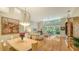 Sun-filled living area with an open floor plan, hardwood floors, and access to a serene outdoor living space at 7133 Victoria Cir, University Park, FL 34201