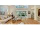 Bright living area featuring hardwood floors, an open floor plan, and sliding glass doors that lead to an outdoor patio at 7133 Victoria Cir, University Park, FL 34201