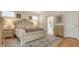 Comfortable bedroom featuring a decorative bed, a warm ambiance, and views of the en-suite bathroom at 7133 Victoria Cir, University Park, FL 34201