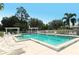 Enjoy this large community pool surrounded by lush trees and comfortable lounge chairs at 7133 Victoria Cir, University Park, FL 34201