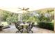 A screened lanai features comfortable seating and serene views of lush landscaping at 7133 Victoria Cir, University Park, FL 34201