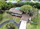 Aerial view of a lovely two-story home with a sparkling pool, a large yard, and mature trees at 730 Rellim Ln, Sarasota, FL 34232