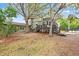 Large backyard featuring a deck, mature trees, and a fenced-in pool area at 730 Rellim Ln, Sarasota, FL 34232