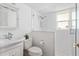 Bathroom featuring a stand-up shower with glass door, updated vanity, and bright window at 730 Rellim Ln, Sarasota, FL 34232