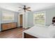 Bright bedroom with natural light, ceiling fan, wood floors, large windows and closet at 730 Rellim Ln, Sarasota, FL 34232