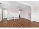 Spacious bedroom with wood floors, pink walls, a ceiling fan, and built-in shelving at 730 Rellim Ln, Sarasota, FL 34232