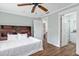 Comfortable bedroom features a ceiling fan, hardwood floors, and a private bathroom for a relaxing retreat at 730 Rellim Ln, Sarasota, FL 34232