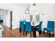 Bright dining area with blue chairs and a wooden table, adjoining the kitchen space at 730 Rellim Ln, Sarasota, FL 34232