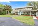Charming two-story home with a well-maintained lawn and landscaping with a driveway at 730 Rellim Ln, Sarasota, FL 34232