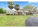 Charming two-story home with a well-maintained lawn, driveway, and vibrant landscaping at 730 Rellim Ln, Sarasota, FL 34232