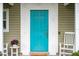 Charming turquoise front door with nautical-themed accents at 730 Rellim Ln, Sarasota, FL 34232