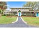 Charming two-story home featuring a welcoming front porch and a beautifully landscaped front yard at 730 Rellim Ln, Sarasota, FL 34232