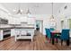 Eat-in kitchen boasts white cabinets, stainless appliances, a central island, and a dining area at 730 Rellim Ln, Sarasota, FL 34232