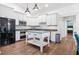 Kitchen features white cabinetry, stainless steel appliances and updated lighting at 730 Rellim Ln, Sarasota, FL 34232