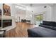 Bright living room with fireplace, pool access, and high ceilings, offering a blend of comfort and style at 730 Rellim Ln, Sarasota, FL 34232