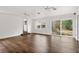 Sun-filled living room boasts hardwood floors, recessed lights, and sliding glass doors to the backyard at 730 Rellim Ln, Sarasota, FL 34232