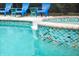 Close-up of a gorgeous pool featuring eye-catching tile and a relaxing water feature at 730 Rellim Ln, Sarasota, FL 34232