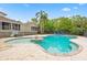 Beautiful backyard pool with a unique shape, brick border, hot tub, and ample seating at 730 Rellim Ln, Sarasota, FL 34232