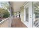 Long screened-in porch features wood floors and white doors, offering an outdoor space at 730 Rellim Ln, Sarasota, FL 34232