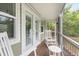 Cozy screened-in porch featuring rocking chairs and a peaceful view of the surrounding landscape at 730 Rellim Ln, Sarasota, FL 34232