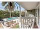 Relaxing screened-in porch offers views of the pool, lush greenery, and comfortable seating at 730 Rellim Ln, Sarasota, FL 34232