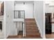 Interior staircase featuring wood steps, custom metal railings, and natural light from the doorway below at 730 Rellim Ln, Sarasota, FL 34232
