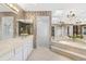 Bright bathroom featuring a soaking tub, walk-in shower, dual sinks and decorative accents at 7300 Wax Myrtle Way, Sarasota, FL 34241