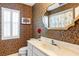 Well decorated bathroom with vanity, mirror, and wallpapered walls at 7300 Wax Myrtle Way, Sarasota, FL 34241
